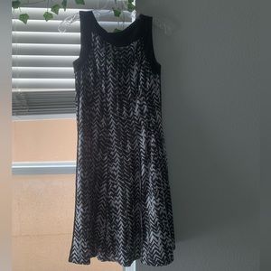 A mini black dress with white stripes. It’s a small.